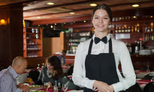 A photo of a happy restaurant worker who uses a laundry service for her restaurant