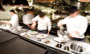 An image of a busy restaurant in the summer season, indicating the need to reevaluate their restaurant laundry service cost